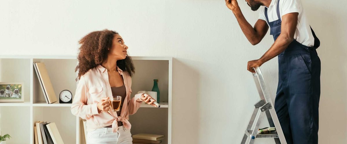 african-american-repairman-fixing-air-conditioner-2022-12-16-16-20-43-utc